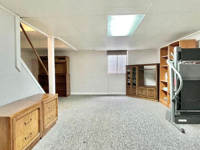 basement with carpet, baseboards, and stairs