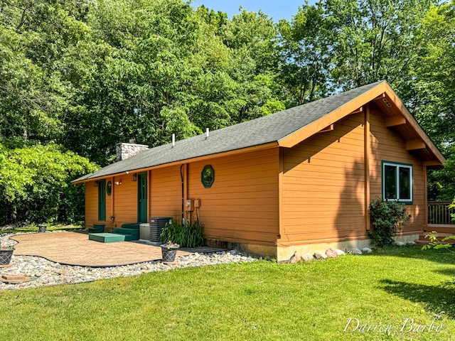3770 Pine Ln, Saranac, MI 48881 - view of front of property with a front lawn, a patio area, a chimney, and a shingled roof