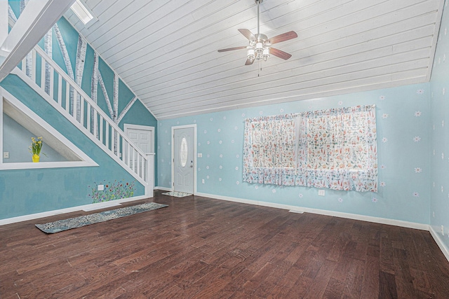 unfurnished living room with baseboards, ceiling fan, wood finished floors, and vaulted ceiling