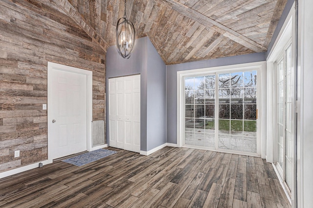 unfurnished bedroom featuring a closet, baseboards, dark wood-type flooring, vaulted ceiling, and wooden ceiling