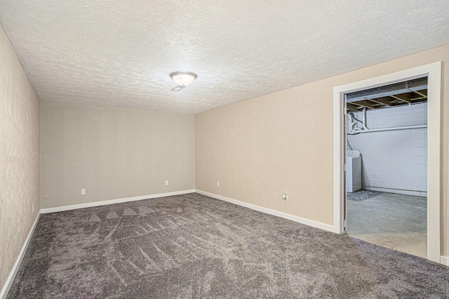 unfurnished bedroom featuring baseboards, carpet floors, washer / dryer, and a textured ceiling