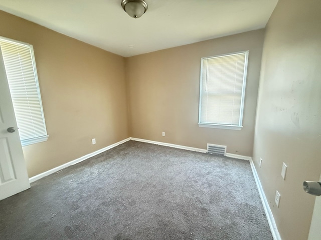 8909 Penrod St, Detroit, MI 48228 - unfurnished room with visible vents, dark colored carpet, and baseboards