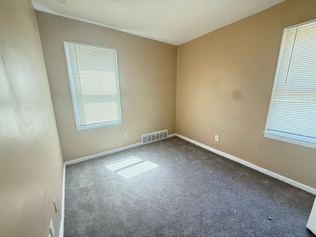 8909 Penrod St, Detroit, MI 48228 - spare room with baseboards, visible vents, and carpet flooring