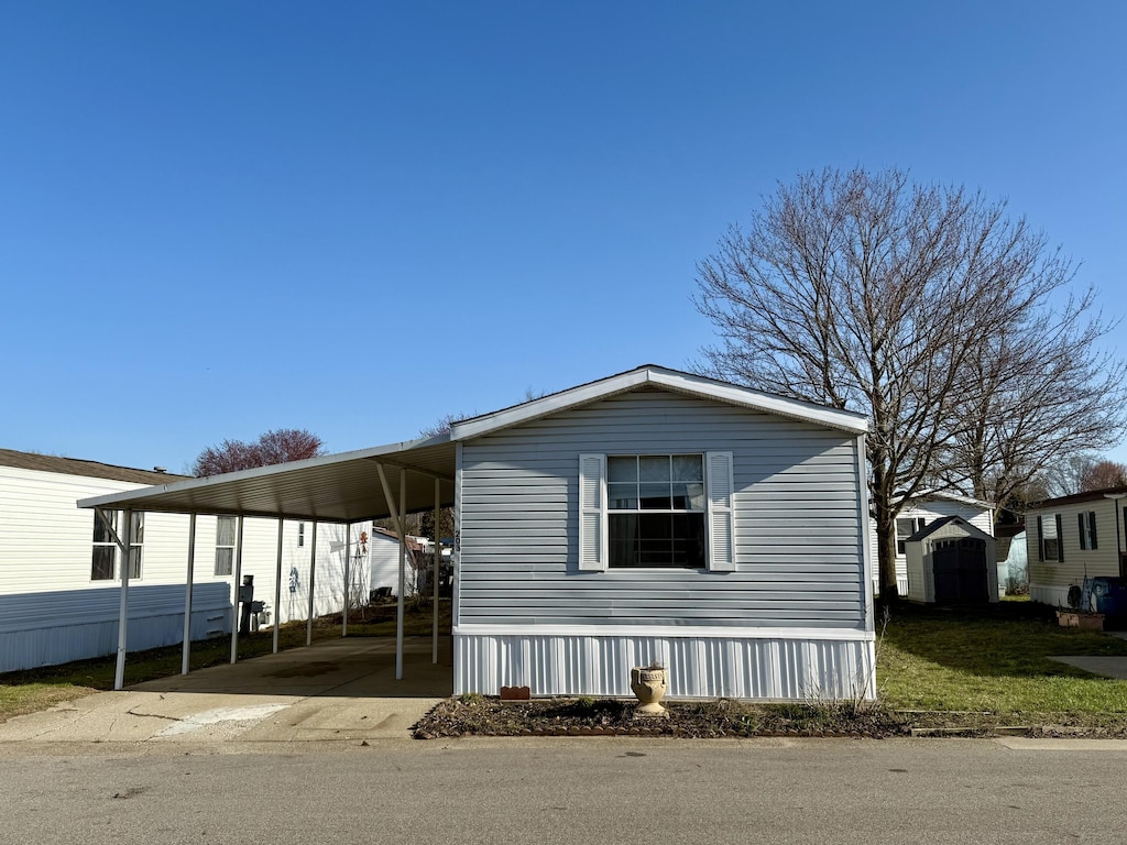 333 E Lakewood Blvd Unit 203, Holland, MI 49424 - view of front facade with driveway and a carport