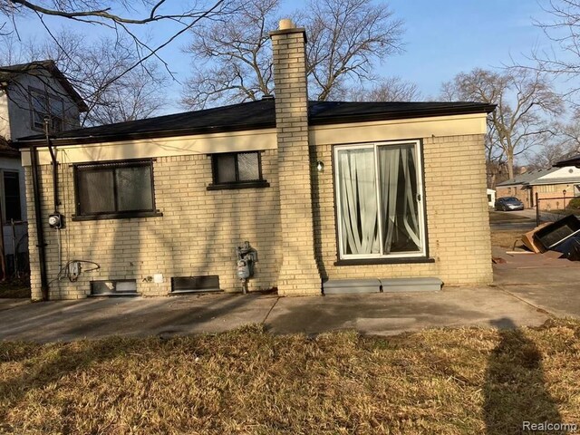 20442 Greenlawn St, Detroit, MI 48221 - rear view of house featuring a chimney and brick siding