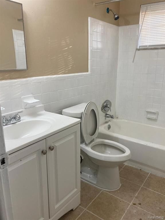 20442 Greenlawn St, Detroit, MI 48221 - full bathroom with tile walls, toilet, vanity, shower / tub combination, and tile patterned flooring