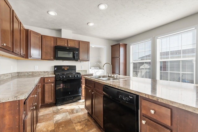 kitchen featuring a sink, a textured ceiling, black appliances, and recessed lighting