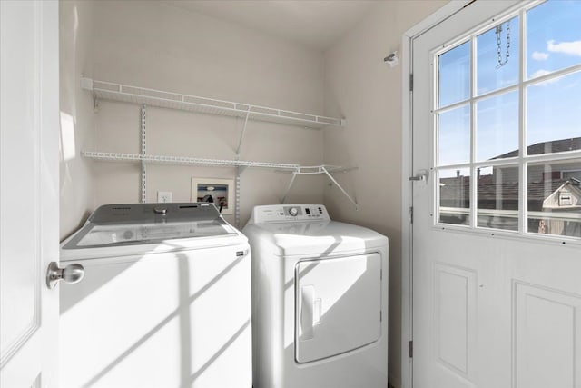 laundry room featuring washing machine and clothes dryer and laundry area