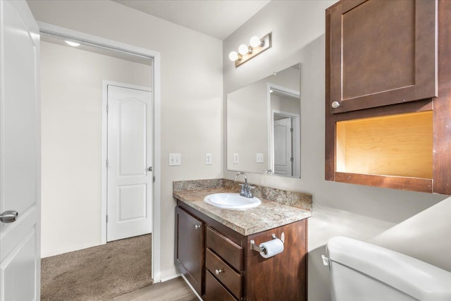 bathroom featuring toilet and vanity