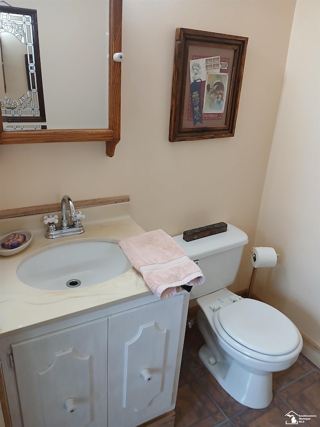 bathroom with toilet and vanity