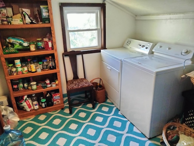 clothes washing area featuring washing machine and dryer and laundry area
