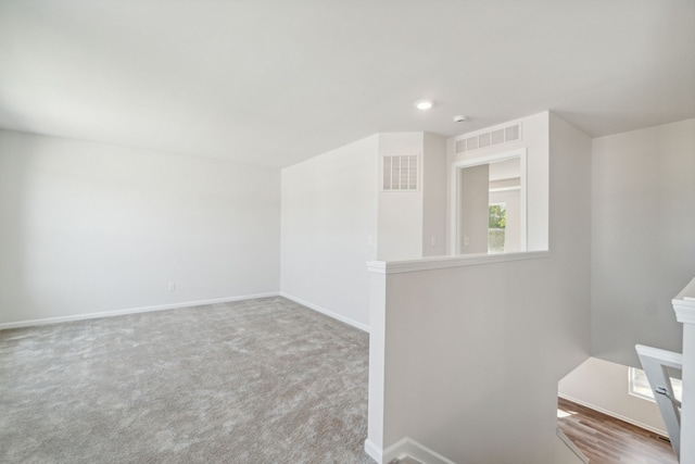carpeted empty room featuring baseboards, recessed lighting, and visible vents