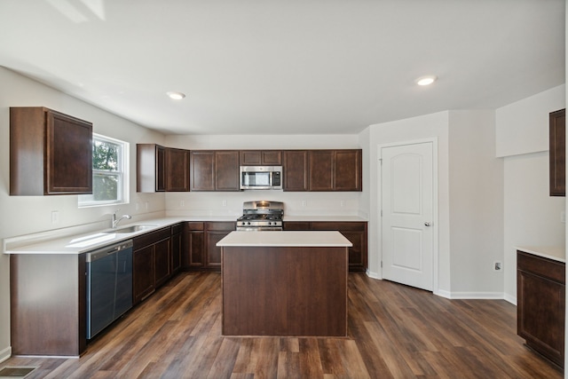 kitchen with a sink, light countertops, stainless steel appliances, and dark wood finished floors