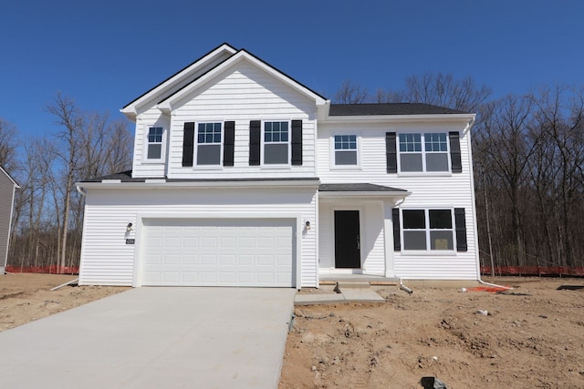traditional-style home with driveway and a garage