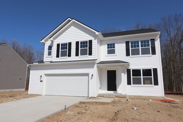 traditional-style home featuring an attached garage and driveway