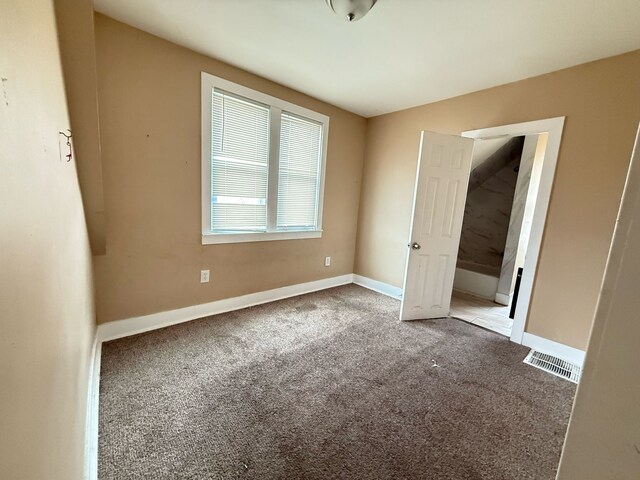11708 Broadstreet Ave, Detroit, MI 48204 - unfurnished bedroom with baseboards, visible vents, and carpet