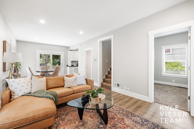 135 Houseman Ave NE, Grand Rapids, MI 49503 - living room featuring wood finished floors, stairway, and recessed lighting