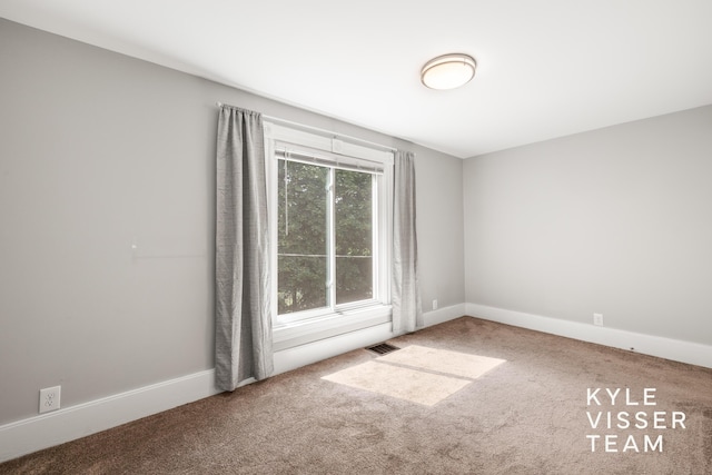 135 Houseman Ave NE, Grand Rapids, MI 49503 - unfurnished room with carpet floors and baseboards