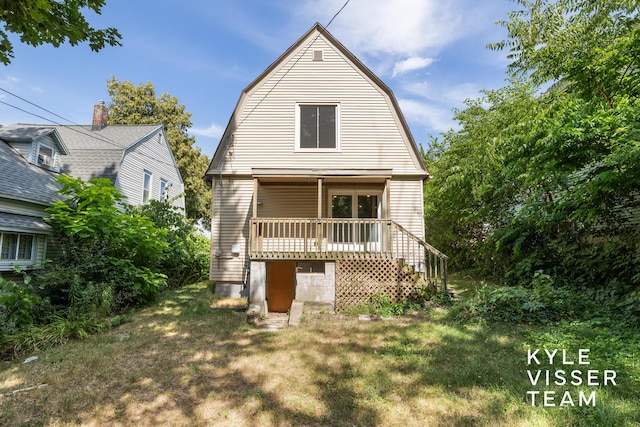 135 Houseman Ave NE, Grand Rapids, MI 49503 - dutch colonial with a gambrel roof, a deck, and stairs