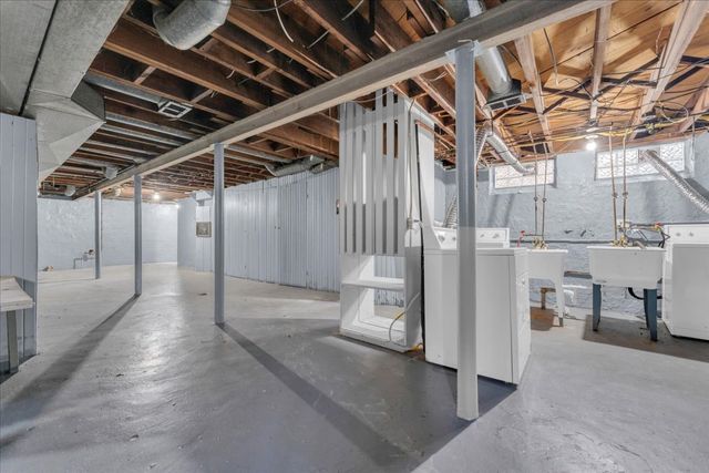 basement with washer and clothes dryer and a sink