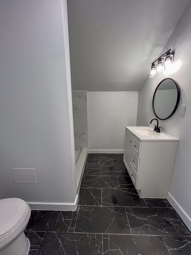 bathroom with toilet, baseboards, marble finish floor, and vanity