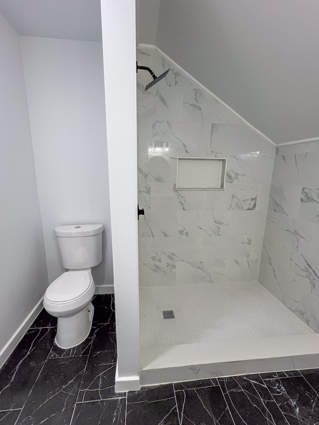 full bathroom with a stall shower, marble finish floor, baseboards, and toilet