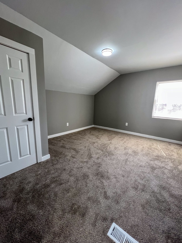 bonus room with carpet, baseboards, and lofted ceiling