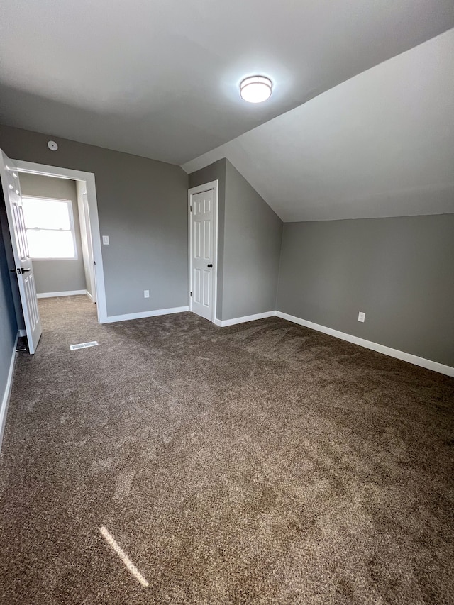 bonus room with carpet, baseboards, and vaulted ceiling