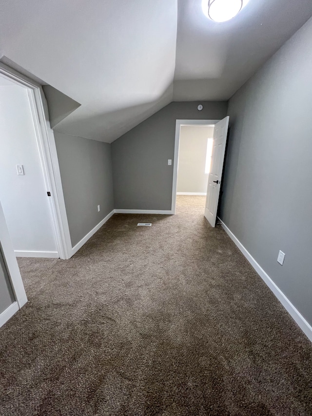 bonus room with visible vents, baseboards, vaulted ceiling, and carpet