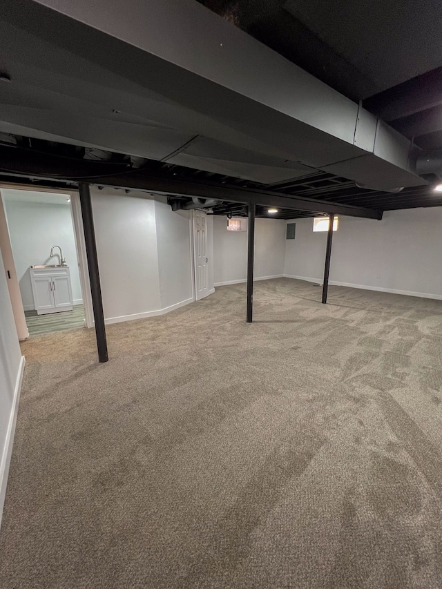 finished below grade area with baseboards and carpet floors