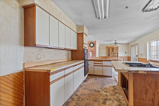 2975 Hadden Rd, Rochester, MI 48306 - kitchen featuring white cabinets, dobule oven black, light countertops, a ceiling fan, and gas stovetop