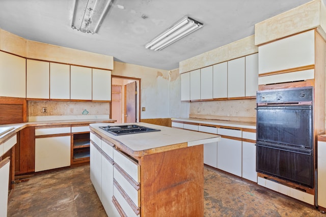 2975 Hadden Rd, Rochester, MI 48306 - kitchen with white cabinets, light countertops, gas stovetop, and a kitchen island