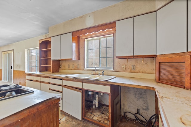 2975 Hadden Rd, Rochester, MI 48306 - kitchen with black electric stovetop, light countertops, open shelves, white cabinets, and a sink