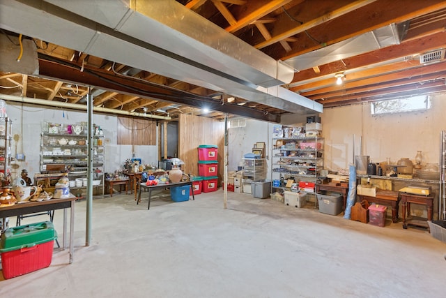 2975 Hadden Rd, Rochester, MI 48306 - basement with visible vents and a workshop area