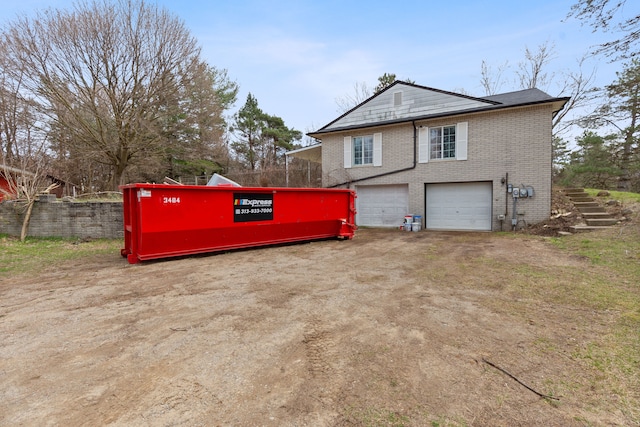 2975 Hadden Rd, Rochester, MI 48306 - view of side of property featuring a garage and brick siding