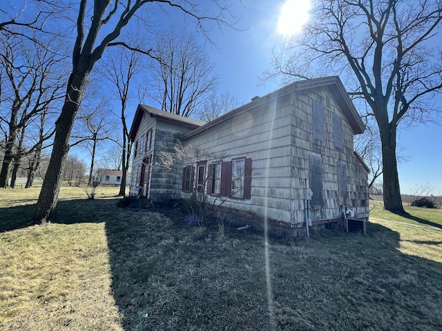 view of property exterior featuring a lawn