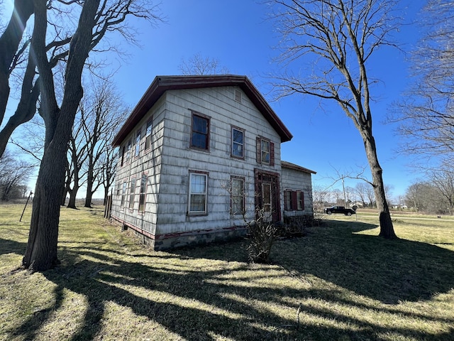 view of property exterior with a yard