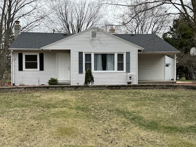 617 Cherry Ave, Big Rapids, MI 49307 - view of front facade with a chimney, a front lawn, and roof with shingles