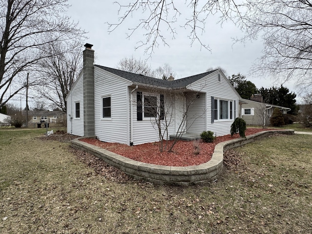 617 Cherry Ave, Big Rapids, MI 49307 - view of side of property featuring a lawn and a chimney