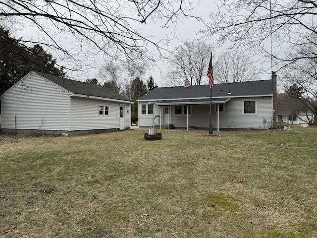 617 Cherry Ave, Big Rapids, MI 49307 - back of house featuring a lawn
