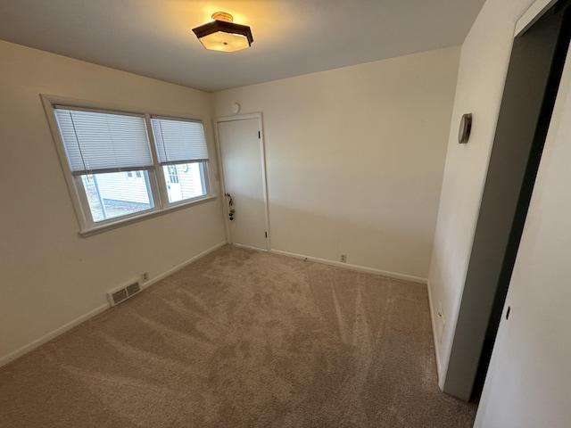 617 Cherry Ave, Big Rapids, MI 49307 - spare room with baseboards, carpet floors, and visible vents