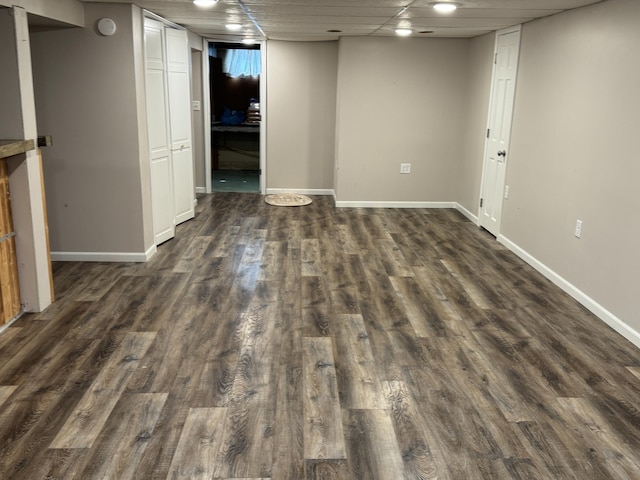 617 Cherry Ave, Big Rapids, MI 49307 - finished below grade area with a drop ceiling, dark wood-style floors, and baseboards