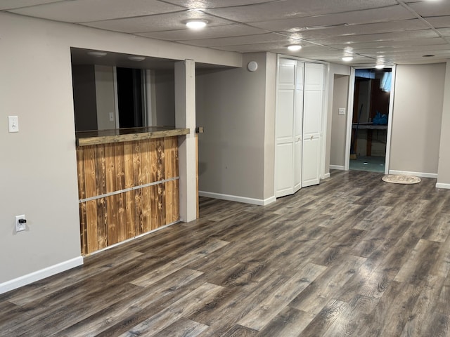 617 Cherry Ave, Big Rapids, MI 49307 - finished below grade area with baseboards, wood finished floors, and a paneled ceiling