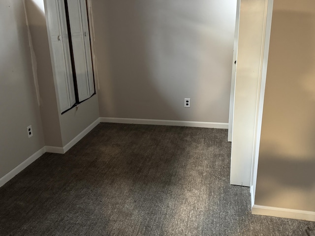 617 Cherry Ave, Big Rapids, MI 49307 - empty room featuring baseboards and dark carpet