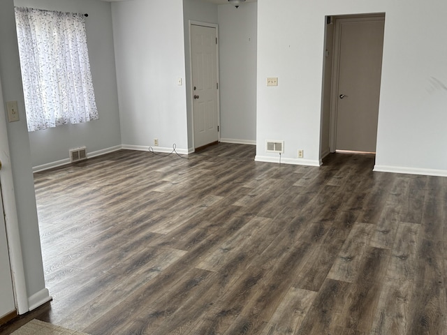 617 Cherry Ave, Big Rapids, MI 49307 - unfurnished room with dark wood-style floors, baseboards, and visible vents