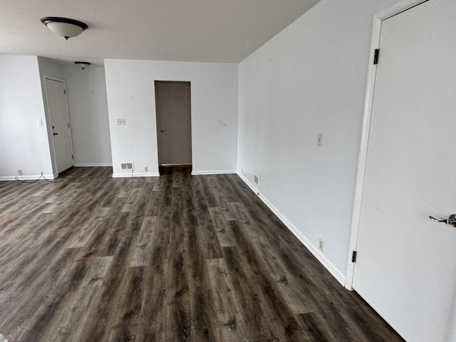 617 Cherry Ave, Big Rapids, MI 49307 - empty room with baseboards, dark wood-style floors, and visible vents