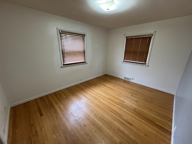 617 Cherry Ave, Big Rapids, MI 49307 - empty room featuring baseboards, visible vents, and light wood-type flooring