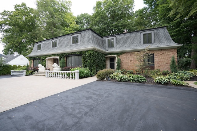 45778 Fermanagh Dr, Northville, MI 48168 - view of front property featuring brick siding, a shingled roof, and mansard roof