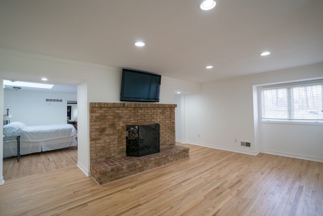 45778 Fermanagh Dr, Northville, MI 48168 - living room with ornamental molding, visible vents, and light wood-style flooring