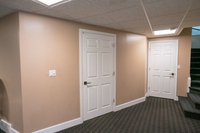 45778 Fermanagh Dr, Northville, MI 48168 - corridor with stairway, a drop ceiling, dark colored carpet, baseboards, and visible vents